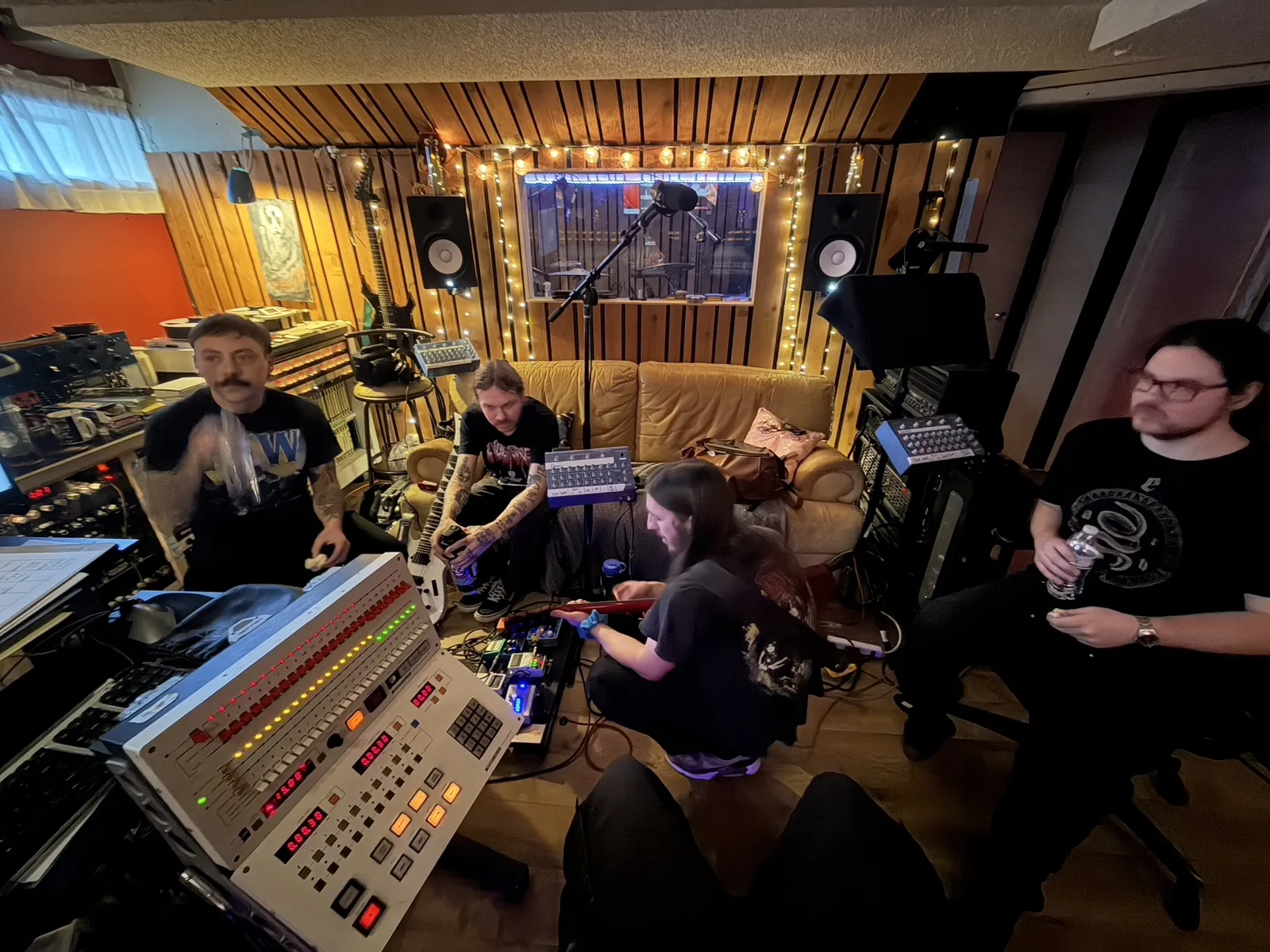 Musicians gathered with instruments in the control room